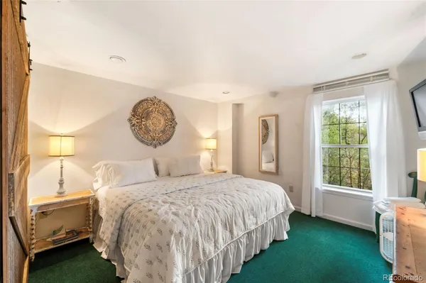 a bedroom with a bed and a window in it