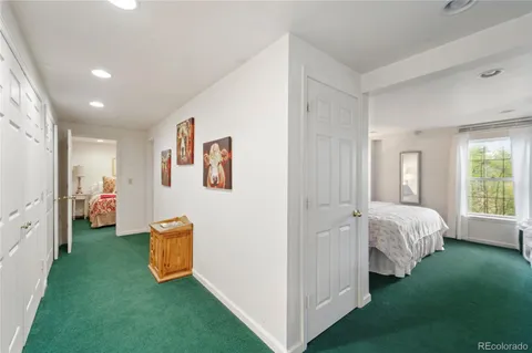 a bedroom with two beds and a potted plant