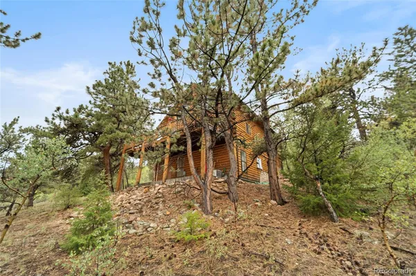 an aerial view of a house with a yard and lake view