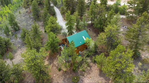 an aerial view of a house with a yard