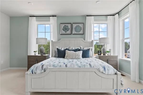 a large bed sitting in a bedroom next to a window