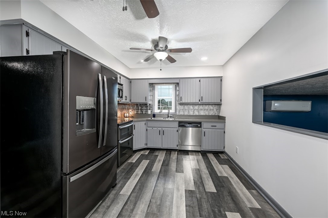 3368 Erhart Road Litchfield, OH 44253 - Photo 7 of 35 Kitchen with dark hardwood floors, stainless steel dishwasher, black fridge with ice dispenser, a textured ceiling, backsplash, white cabinets, light countertops, electric stove, and ceiling fan
