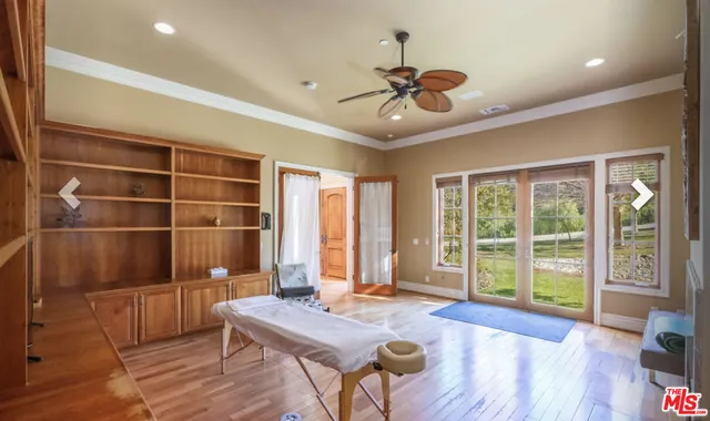 a view of a livingroom with furniture window and wooden floor