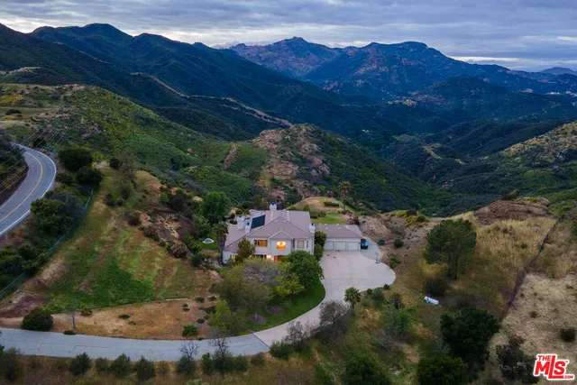 a view of a lush green hillside and houses