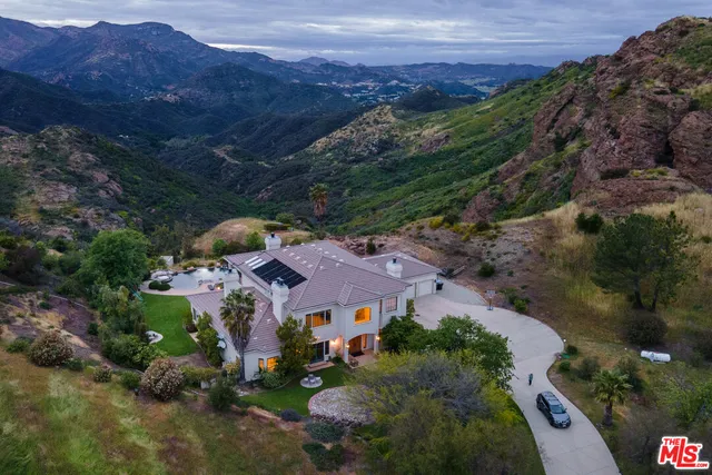 an aerial view of house with a yard