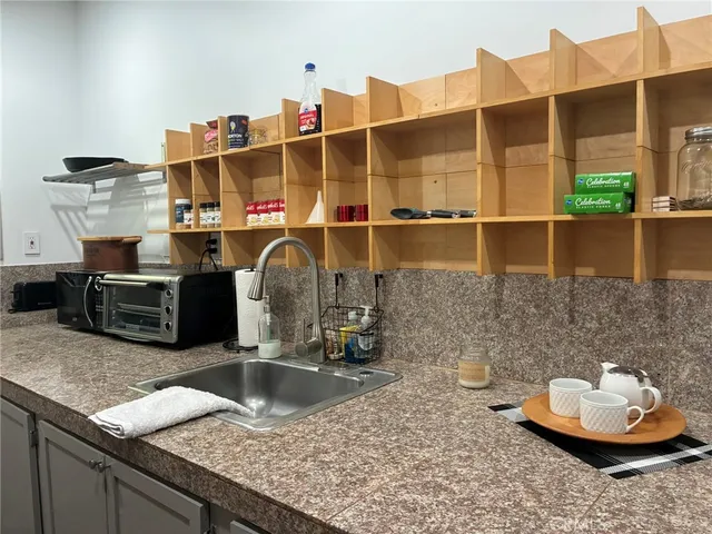 a kitchen with stainless steel appliances granite countertop a sink and a wooden cabinets