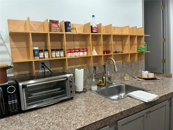 a kitchen with a sink and a counter top space