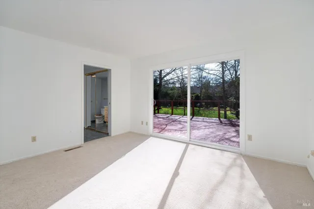 a bedroom with a bed and large window