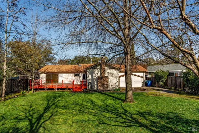 a view of a yard with a house in a big yard