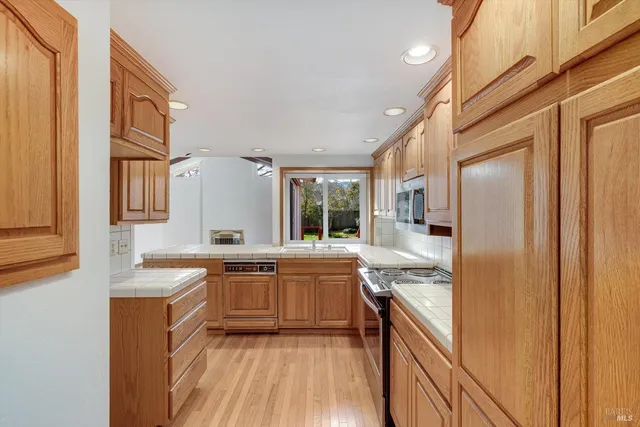 a kitchen with stainless steel appliances granite countertop a sink and cabinets