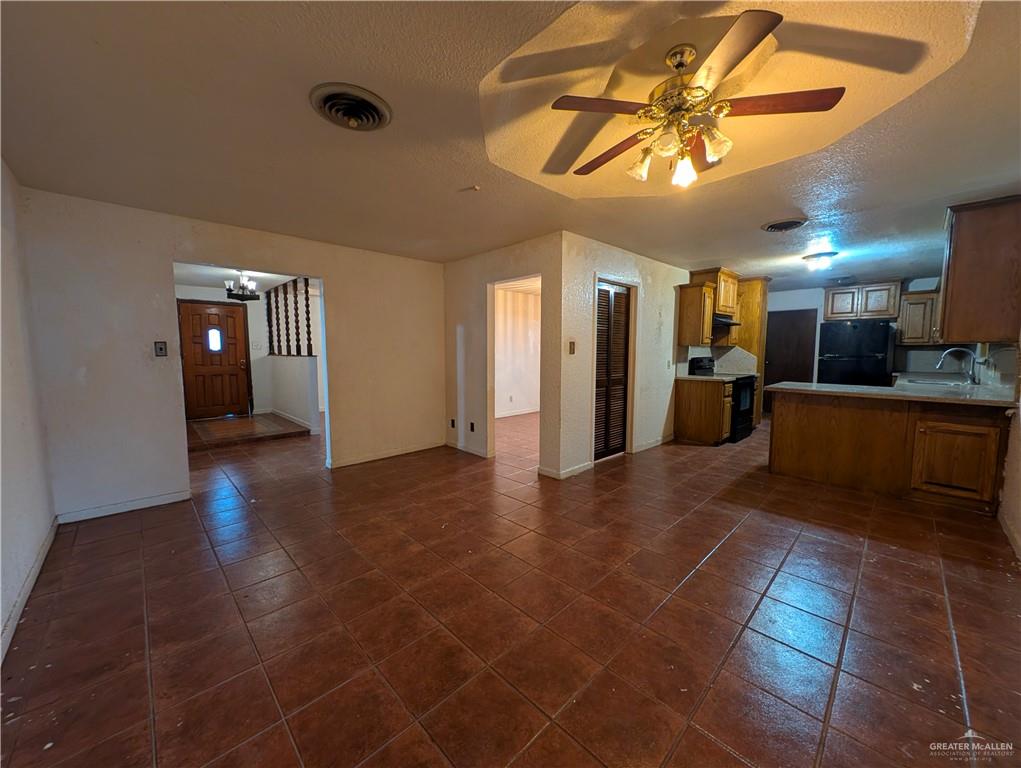 2012 Spring Glenn Avenue Mission, TX 78572 - Photo 6 of 20 a view of a hall with the floor to ceiling window and a kitchen view