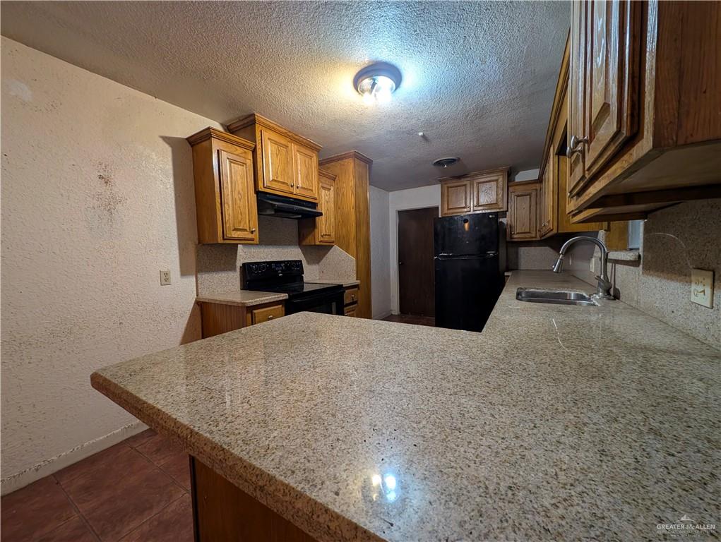 2012 Spring Glenn Avenue Mission, TX 78572 - Photo 9 of 20 a kitchen with a refrigerator and a sink