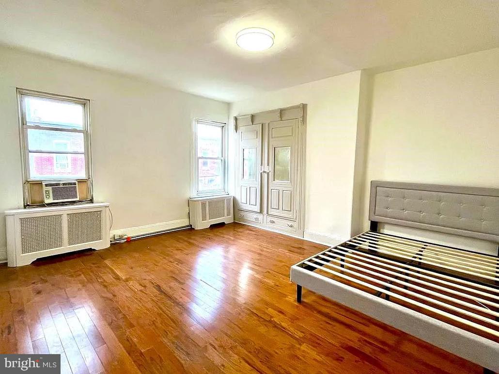 2127 Tasker Street, Unit 2 Philadelphia, PA 19145 - Photo 3 of 5 a view of a room with wooden floor and cabinet