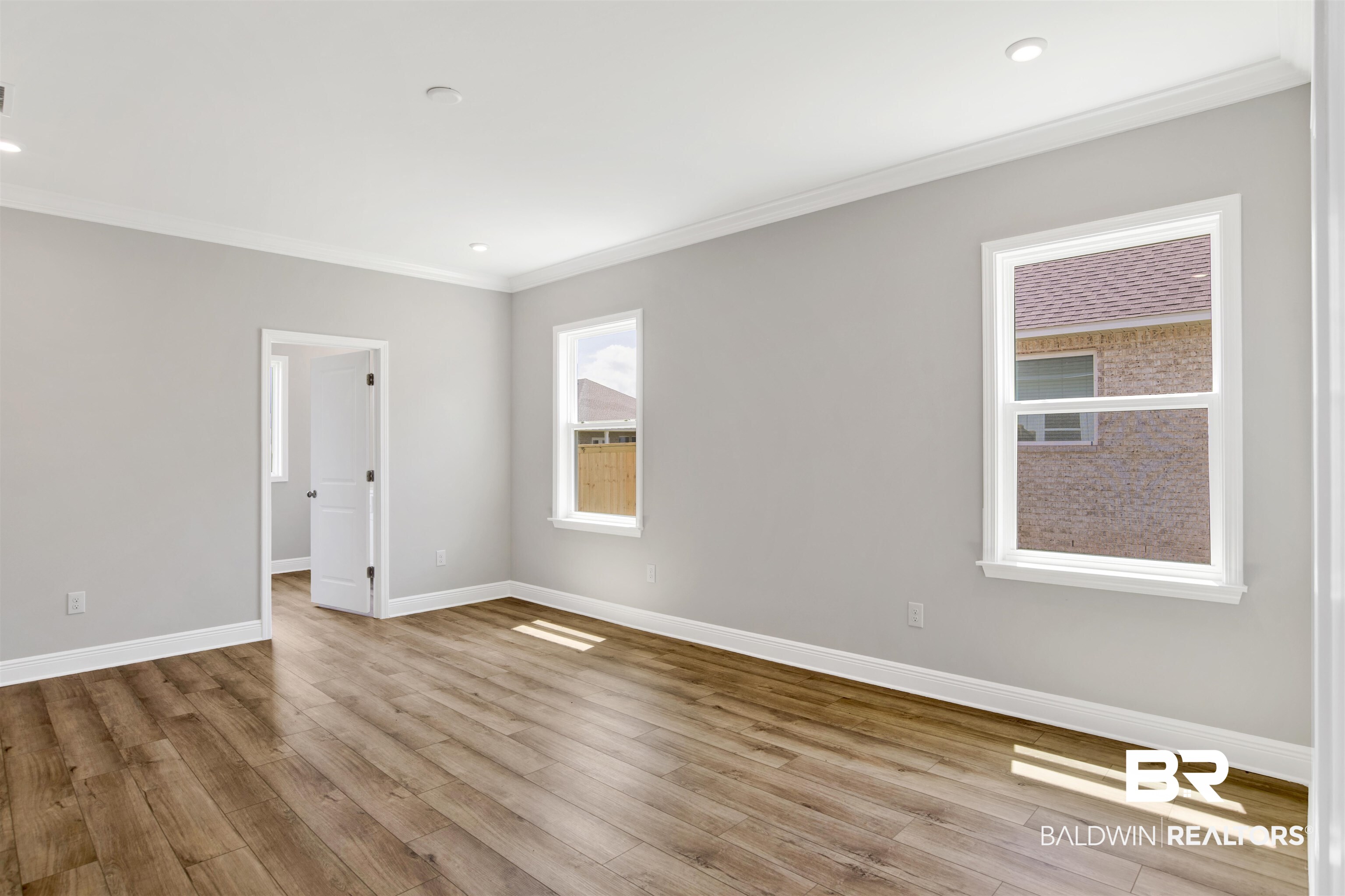 23852 Lafite Circle Daphne, AL 36526 - Photo 15 of 30 Spare room with wood finished floors, ornamental molding, and recessed lighting