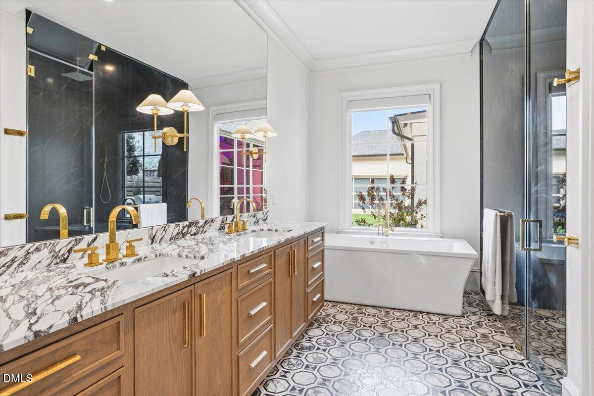 2123 St Marys Street Raleigh, NC 27608 - Photo 28 of 77 a bathroom with a granite countertop sink mirror vanity bathtub and next to a window