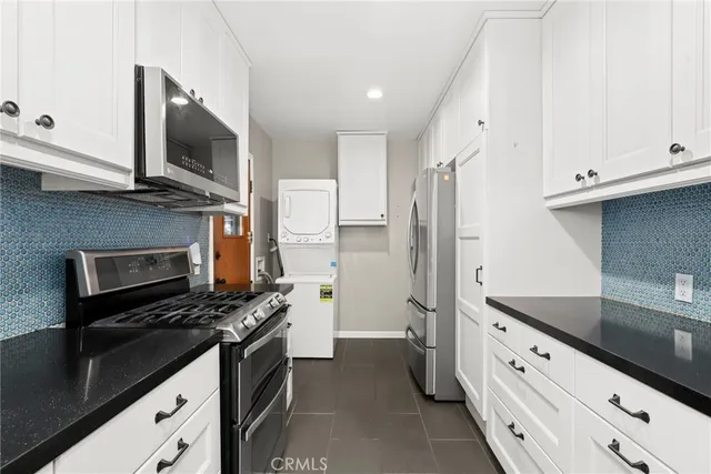 a kitchen with stainless steel appliances a stove microwave and refrigerator