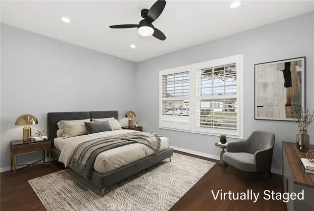 a spacious bedroom with a bed a couch and a window