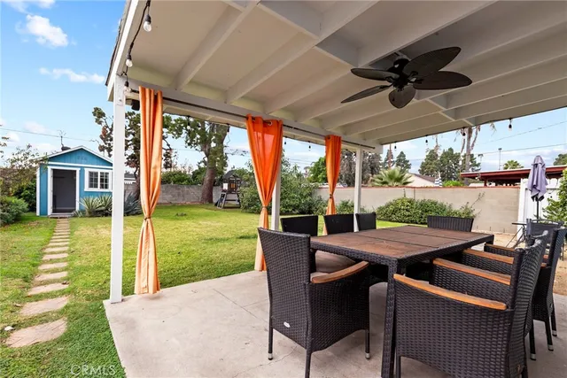 a view of a patio with a table chairs and backyard