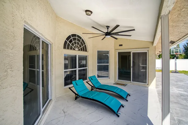 a view of empty room with window and chandelier