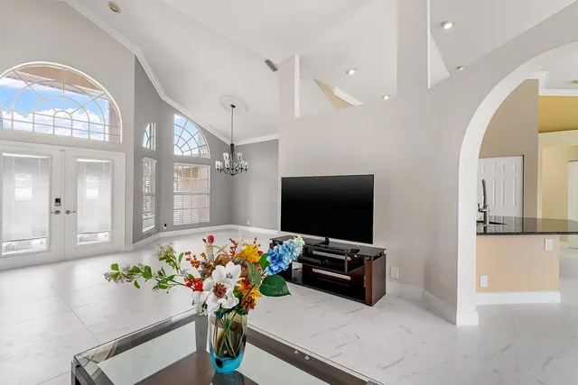 a living room with furniture and a chandelier