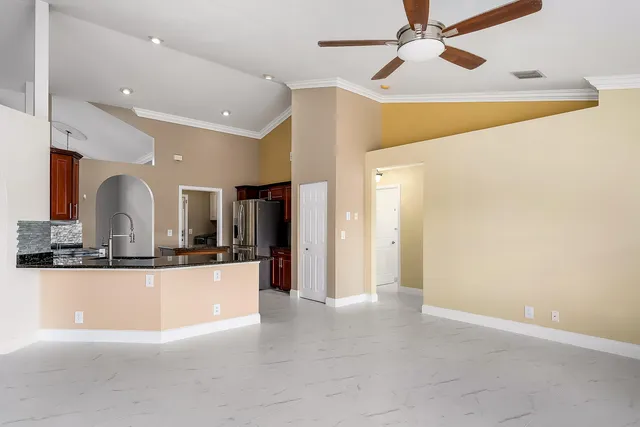 a kitchen with granite countertop cabinets stove top oven and microwave