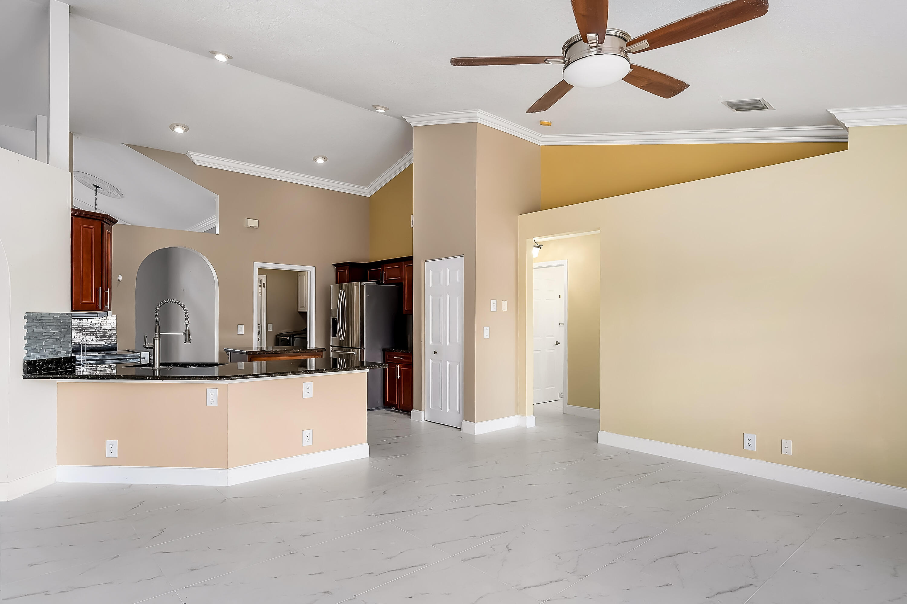 2962 Southwest Coastal Terrace Port St. Lucie, FL 34953 - Photo 25 of 59 a view of a living room with kitchen island and a chandelier