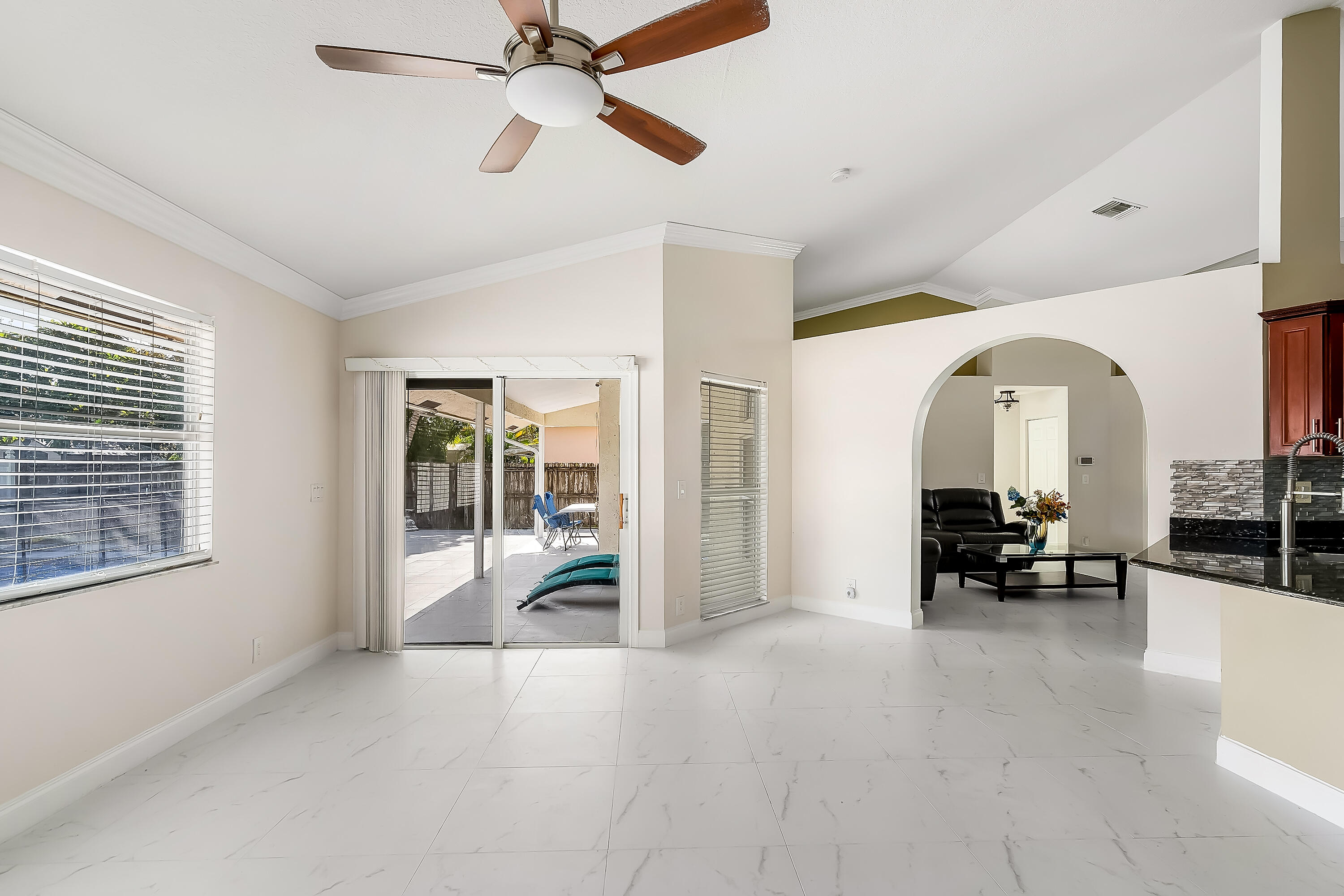 2962 Southwest Coastal Terrace Port St. Lucie, FL 34953 - Photo 27 of 59 a living room with furniture and a chandelier