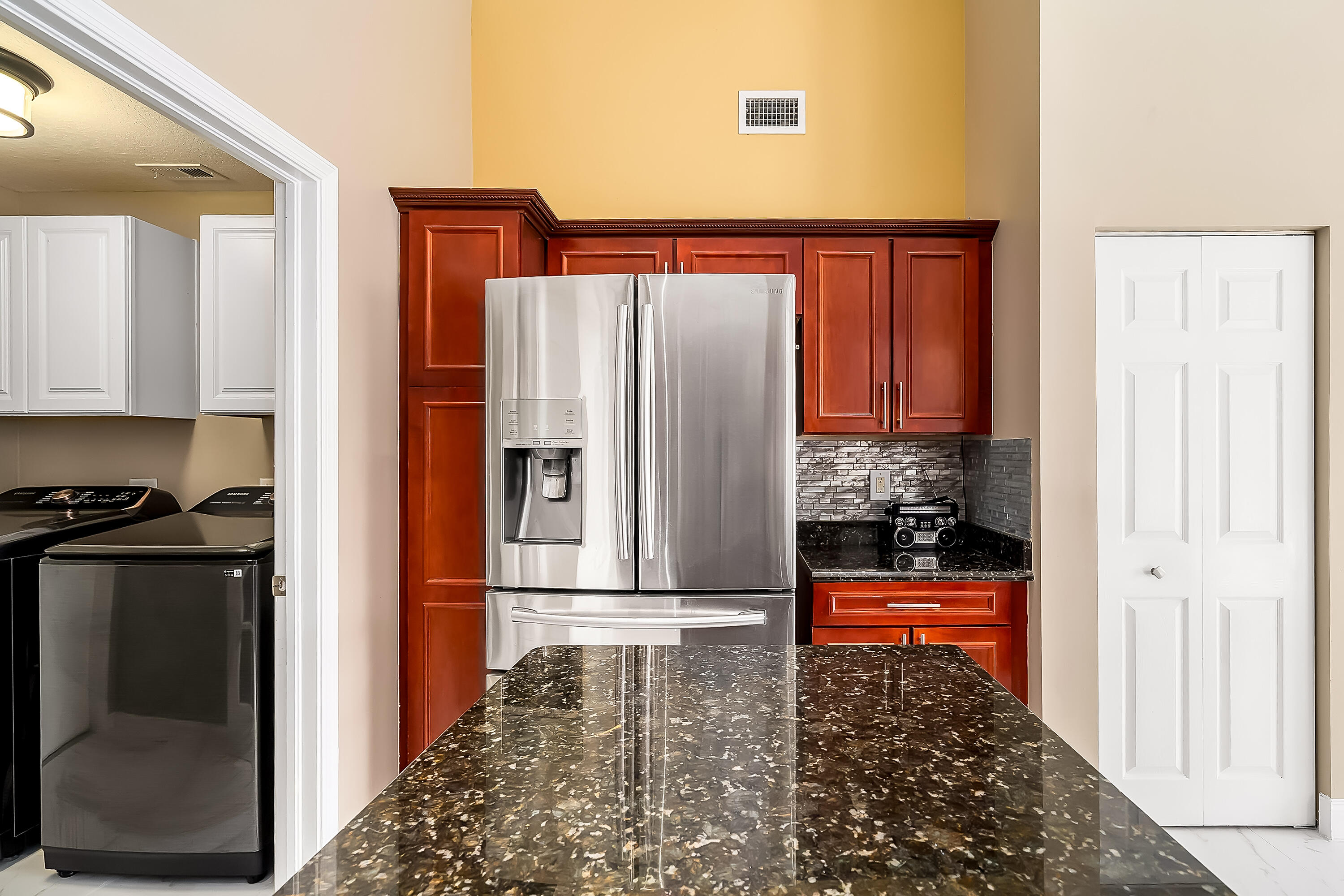 2962 Southwest Coastal Terrace Port St. Lucie, FL 34953 - Photo 30 of 59 a kitchen with stainless steel appliances granite countertop a refrigerator and a stove