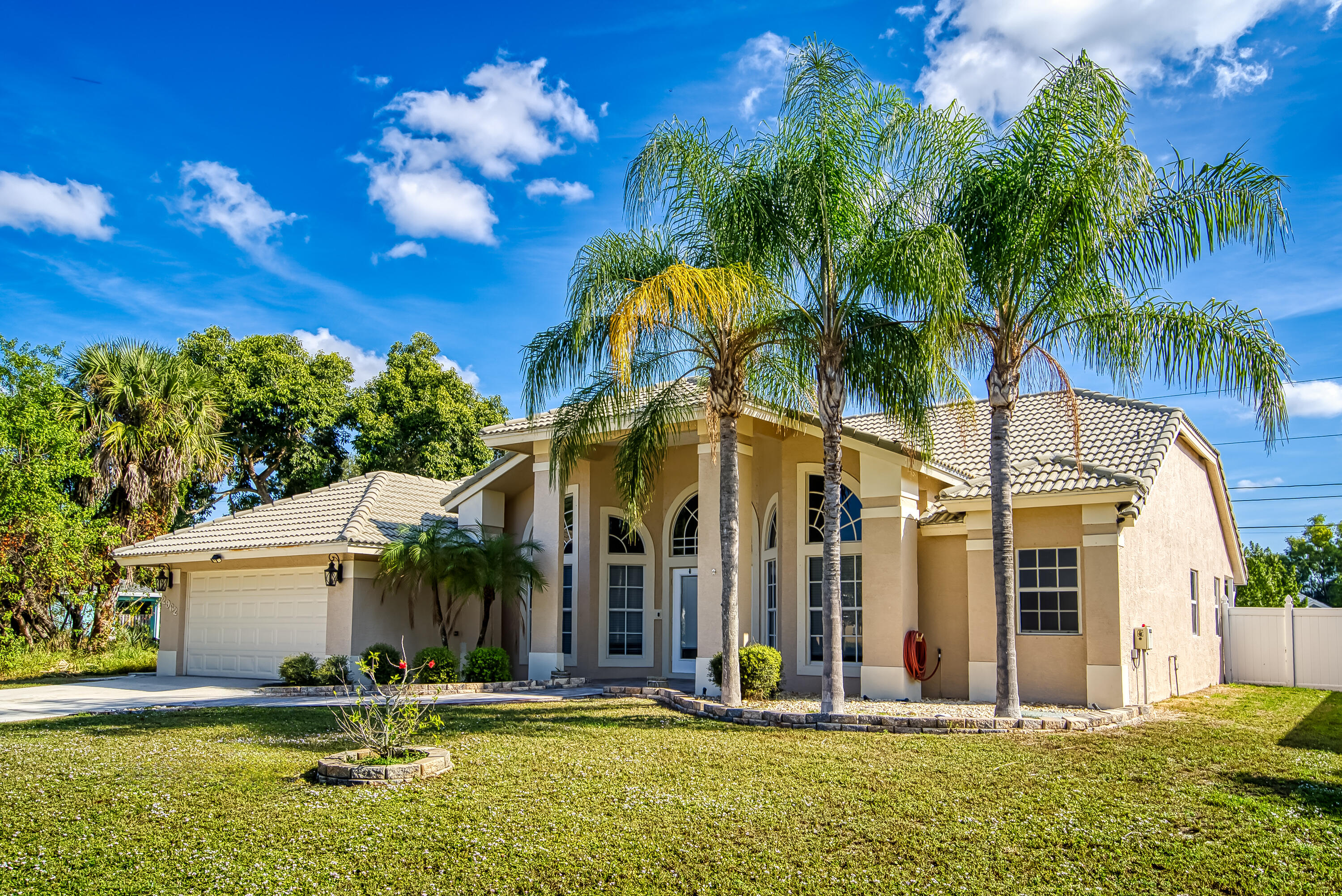 2962 Southwest Coastal Terrace Port St. Lucie, FL 34953 - Photo 3 of 59 a backyard of a house with table and chairs