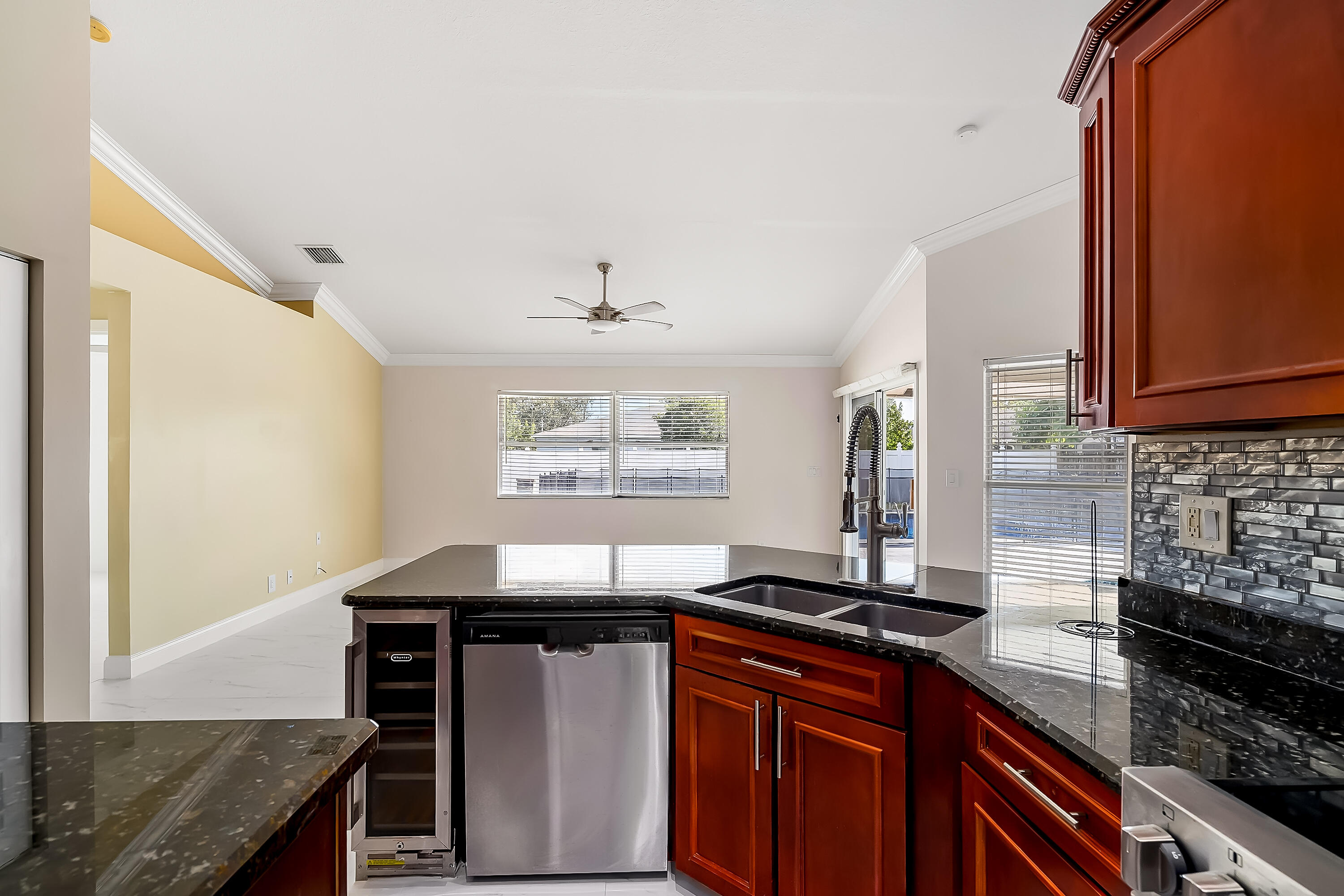 2962 Southwest Coastal Terrace Port St. Lucie, FL 34953 - Photo 31 of 59 a kitchen with stainless steel appliances granite countertop a sink stove and cabinets