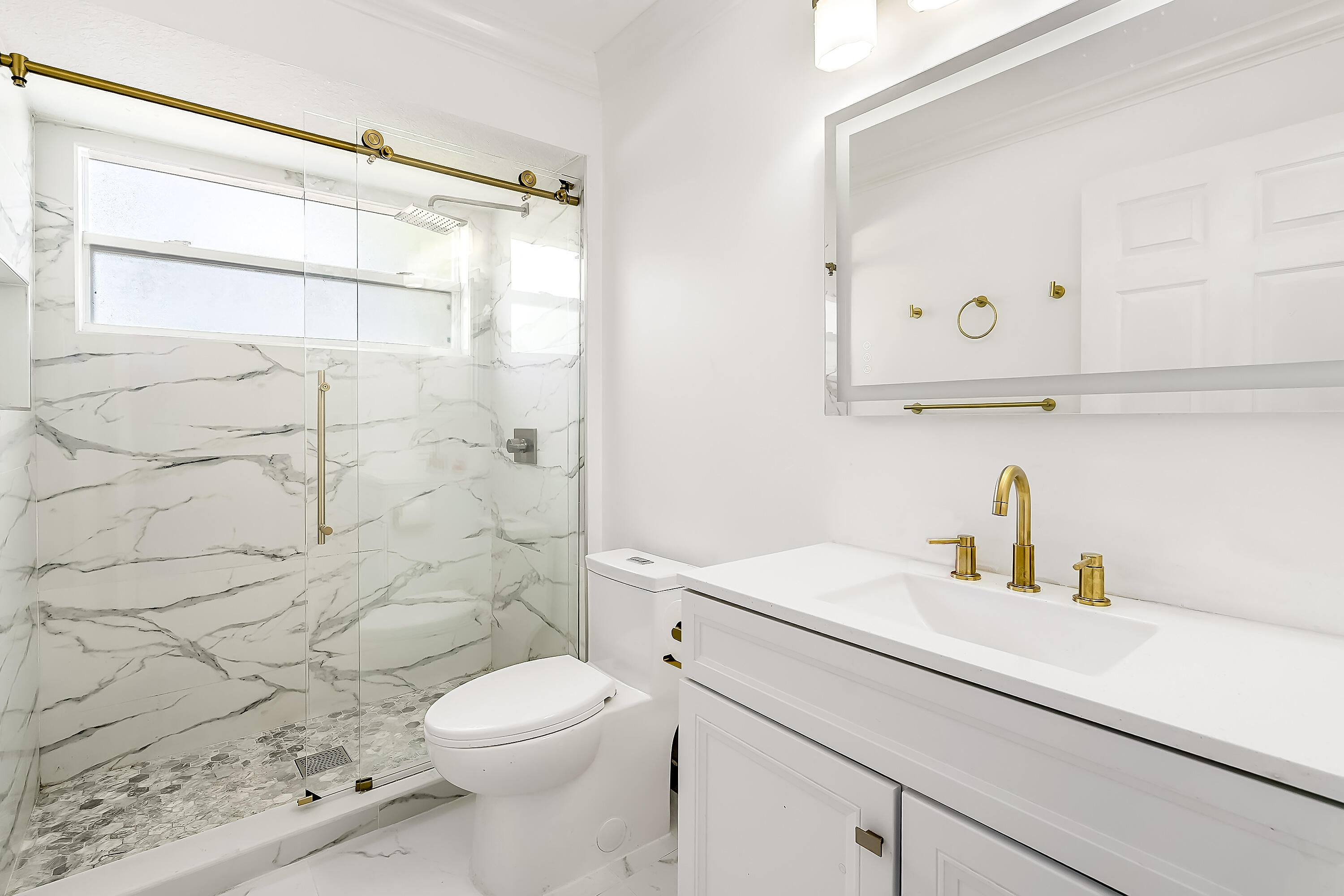 2962 Southwest Coastal Terrace Port St. Lucie, FL 34953 - Photo 38 of 59 a bathroom with a sink a toilet and shower