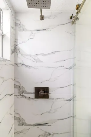 a bathroom with a tub sink and mirror