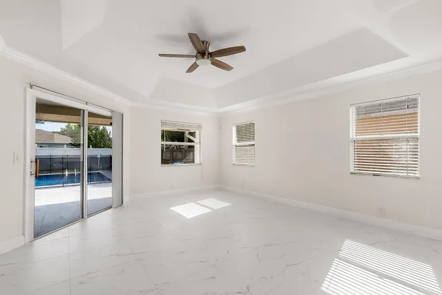 a bathroom with a bathtub and next to a window