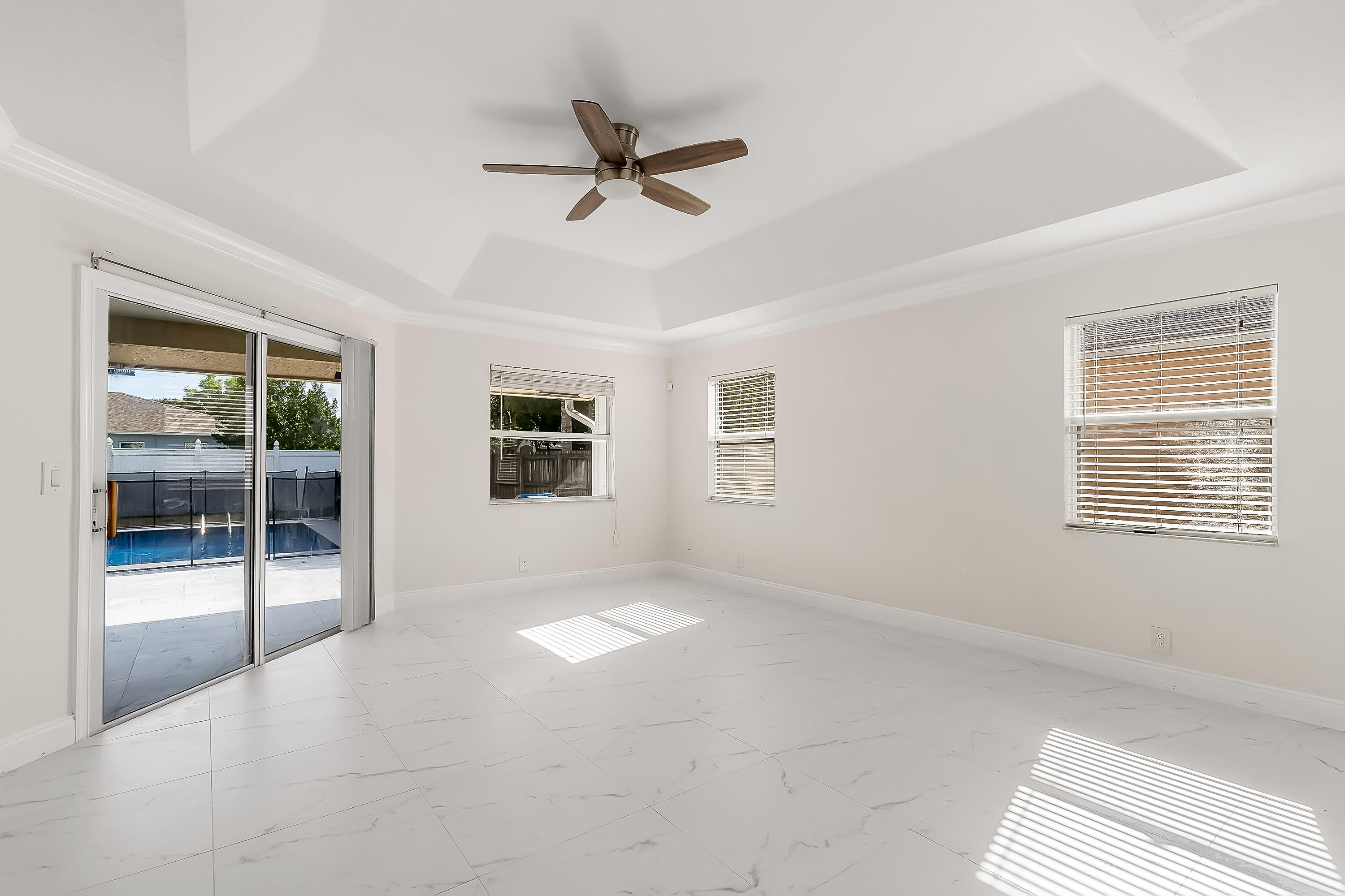 2962 Southwest Coastal Terrace Port St. Lucie, FL 34953 - Photo 43 of 59 a view of a livingroom with a ceiling fan and window