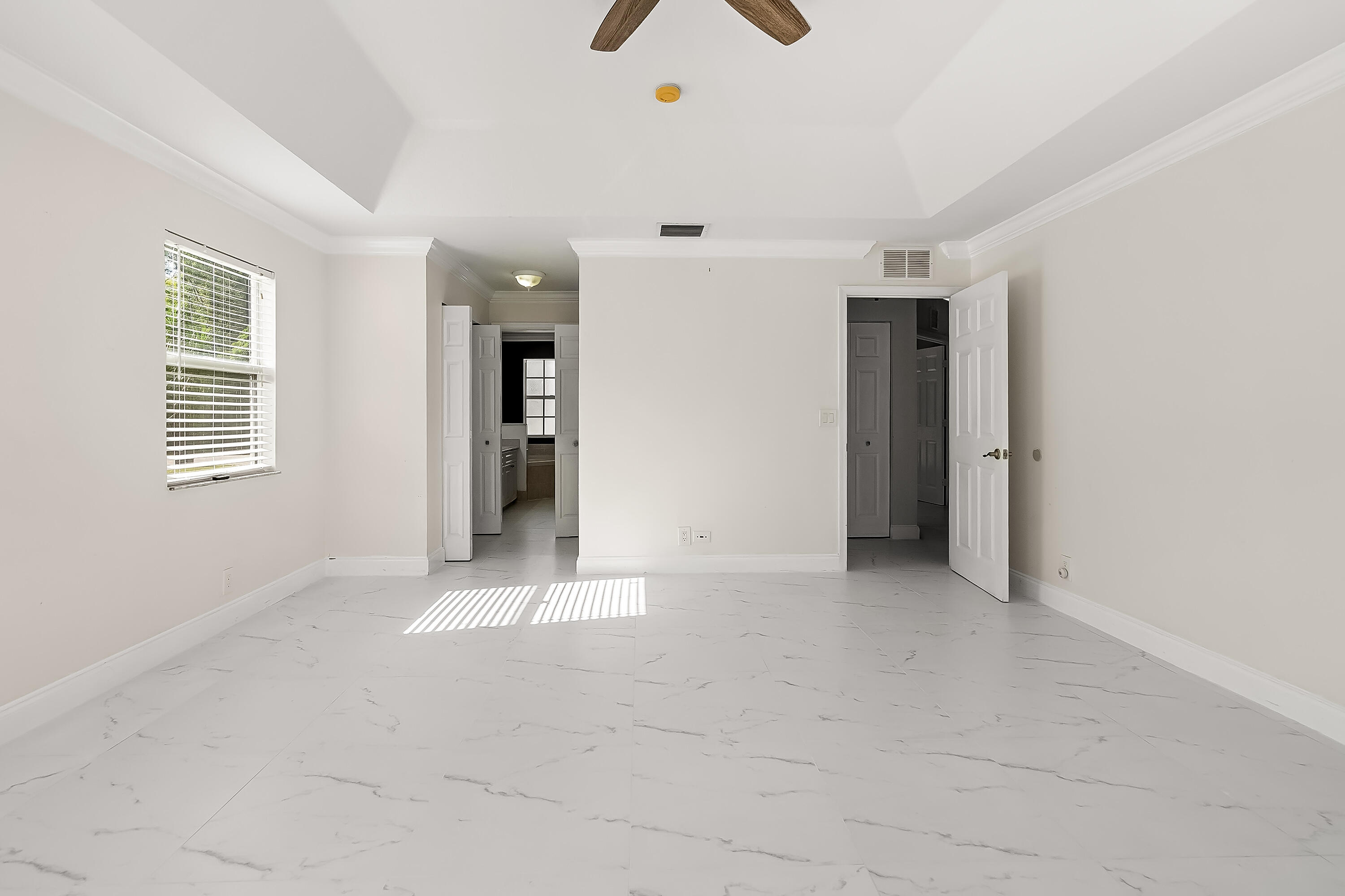 2962 Southwest Coastal Terrace Port St. Lucie, FL 34953 - Photo 45 of 59 an empty room with chandelier fan and windows