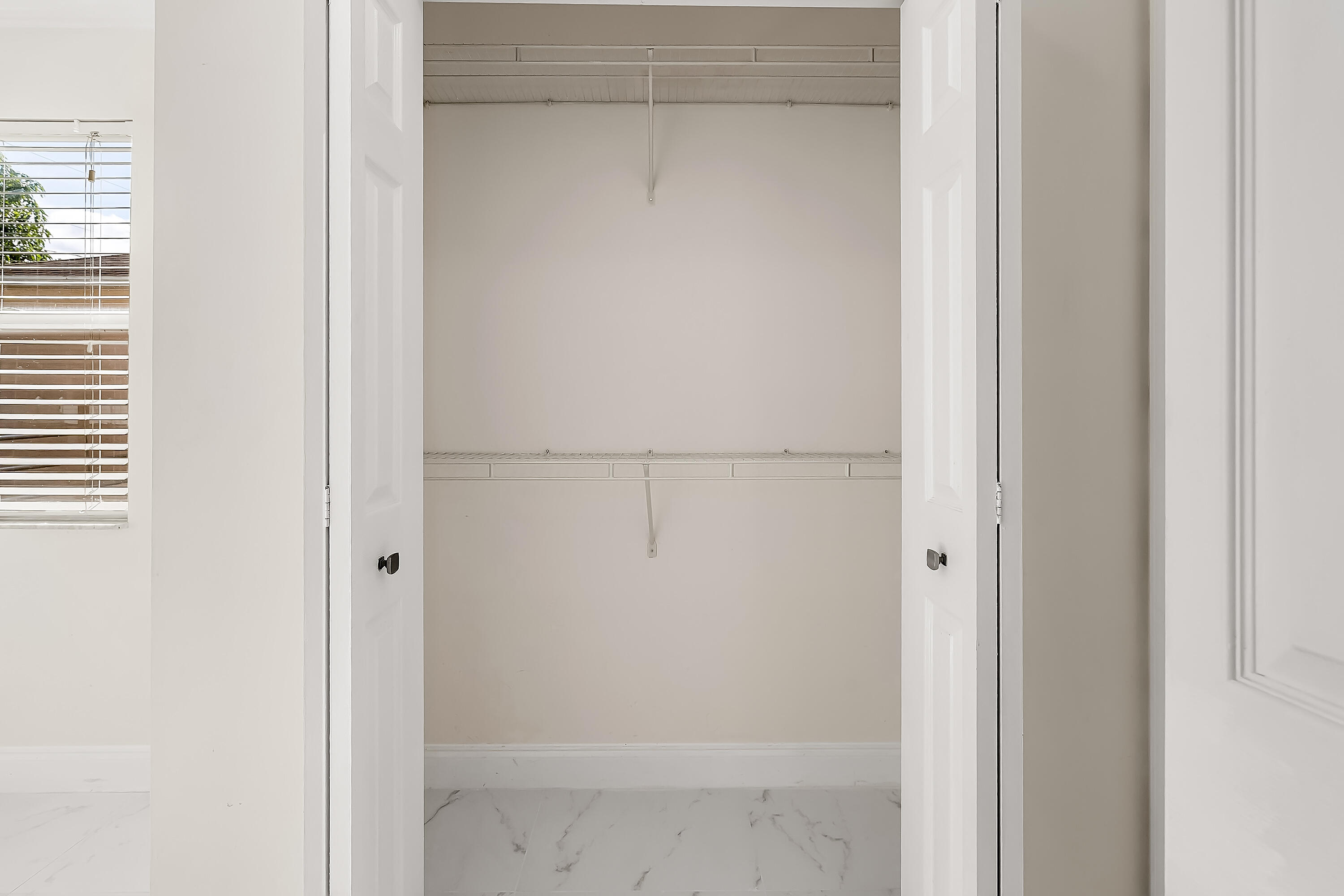 2962 Southwest Coastal Terrace Port St. Lucie, FL 34953 - Photo 46 of 59 a bathroom with a glass shower door