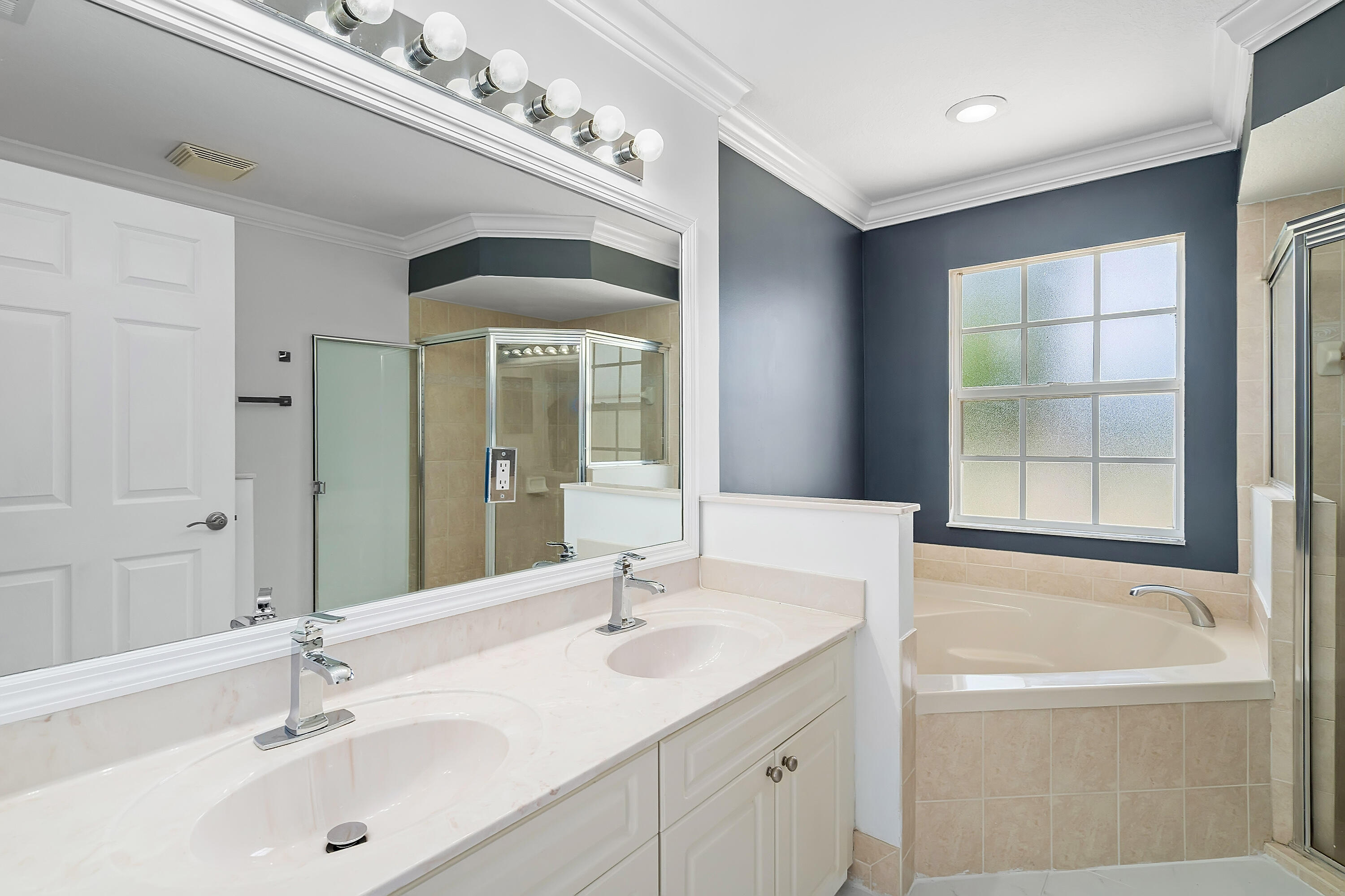 2962 Southwest Coastal Terrace Port St. Lucie, FL 34953 - Photo 48 of 59 a bathroom with a tub sink and mirror