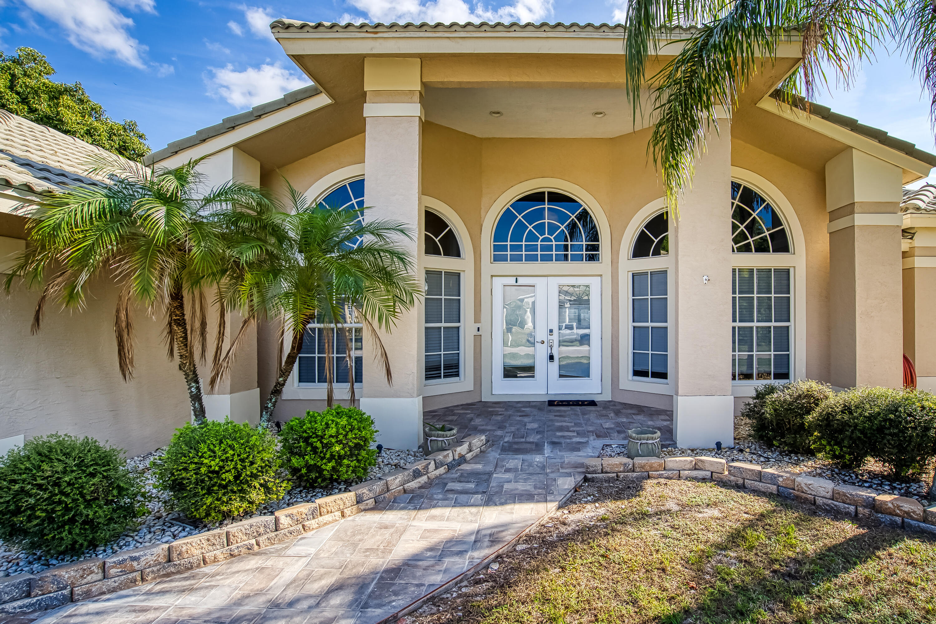 2962 Southwest Coastal Terrace Port St. Lucie, FL 34953 - Photo 5 of 59 a house with palm tree in front of it