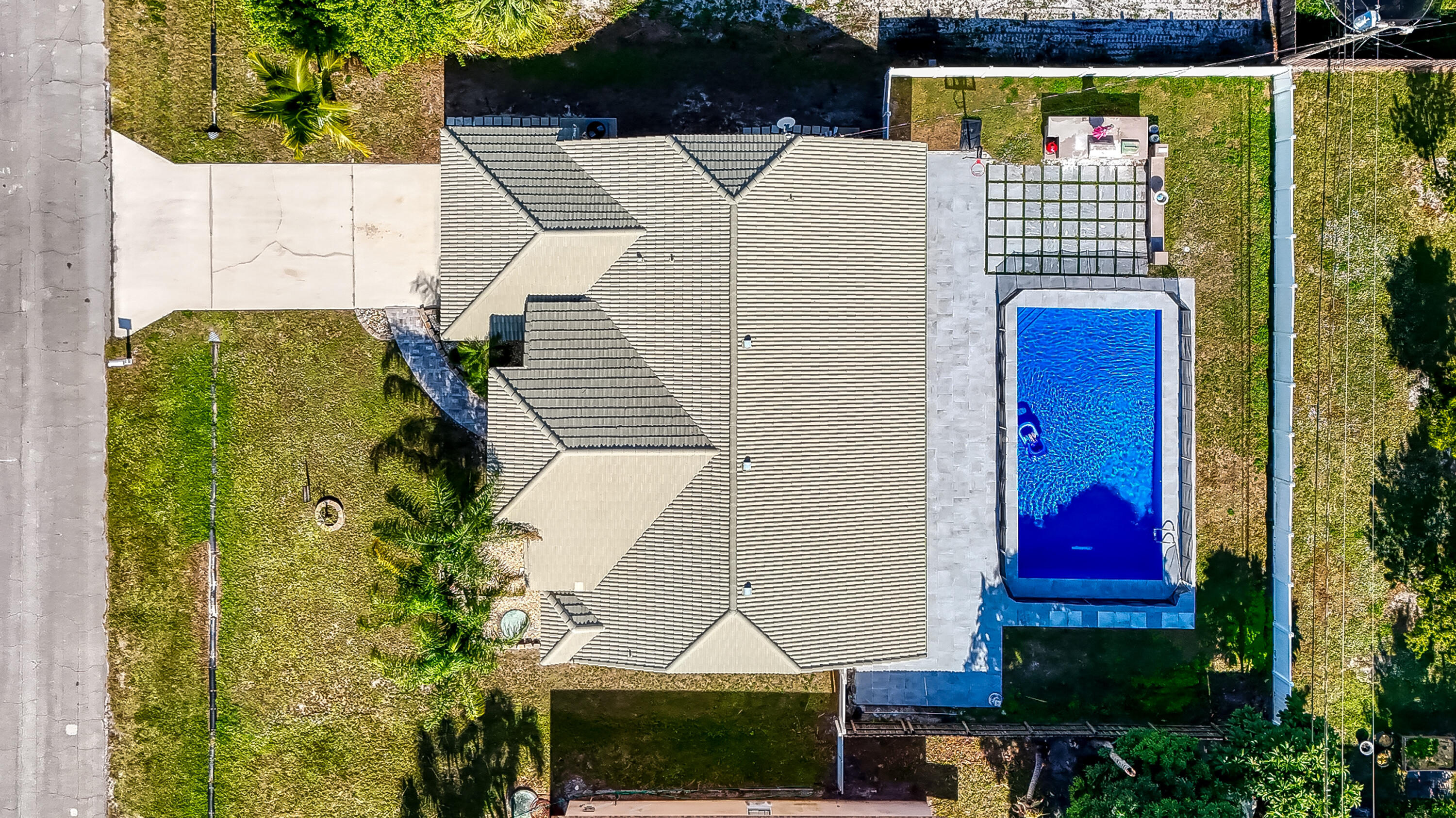 2962 Southwest Coastal Terrace Port St. Lucie, FL 34953 - Photo 54 of 59 a view of swimming pool with lawn chairs and potted plants