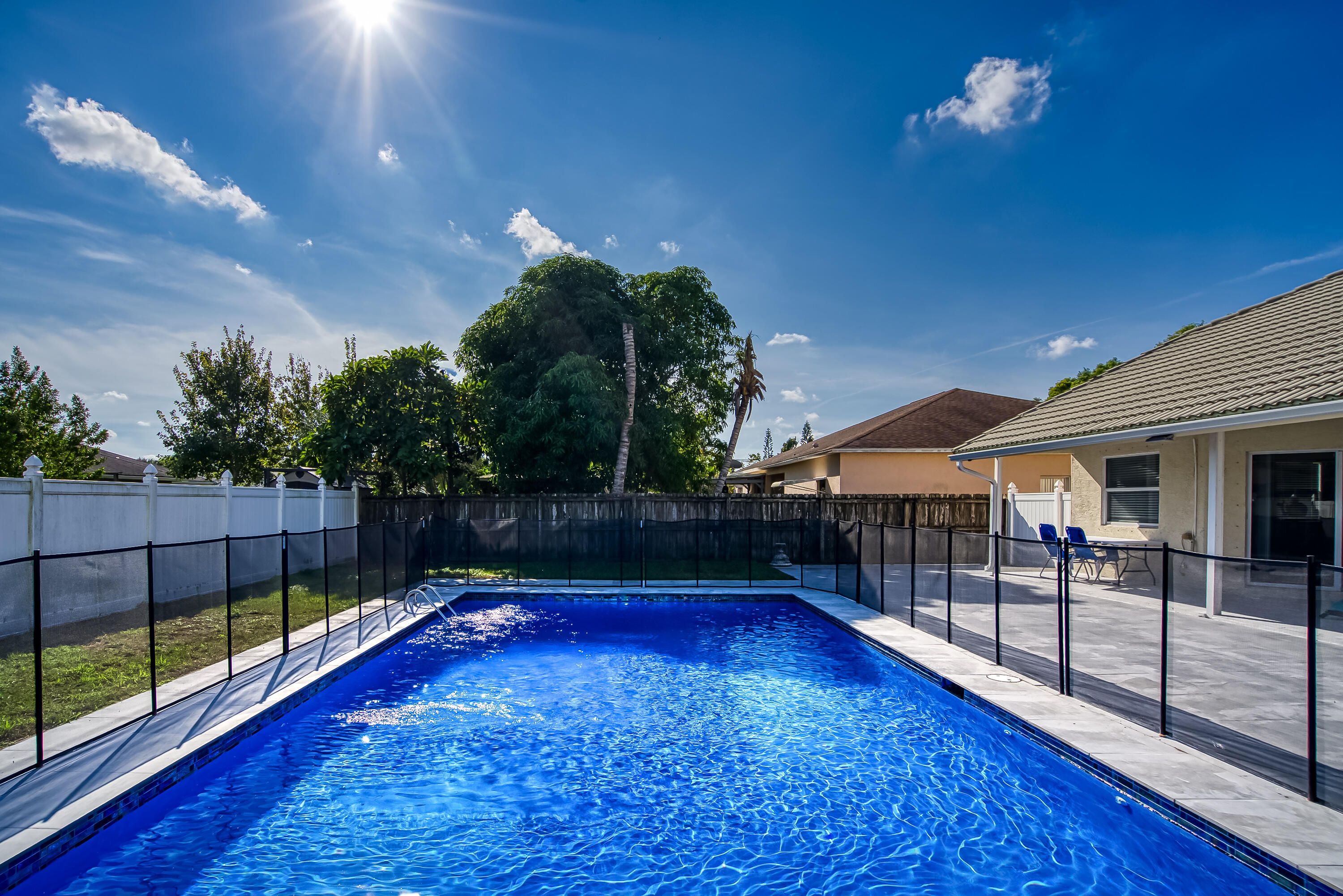 2962 Southwest Coastal Terrace Port St. Lucie, FL 34953 - Photo 8 of 59 a view of a swimming pool with a patio