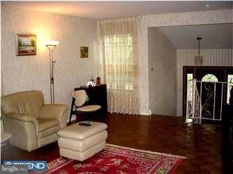 838 Hendrix Street Philadelphia, PA 19116 - Photo 2 of 12 a living room with furniture a window and a chandelier