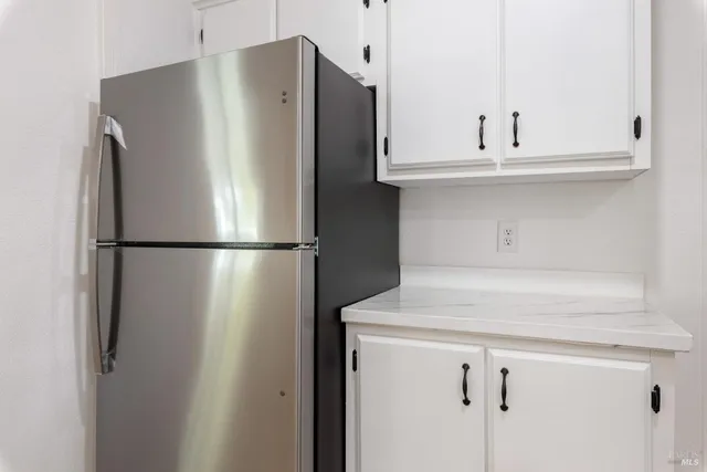 a white refrigerator freezer sitting inside of a kitchen