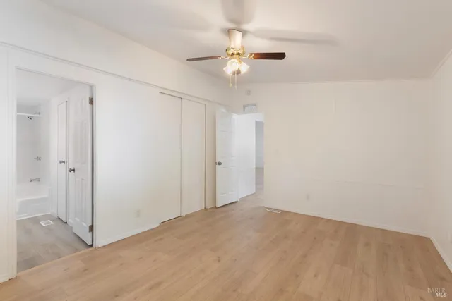 a view of a room with a ceiling fan