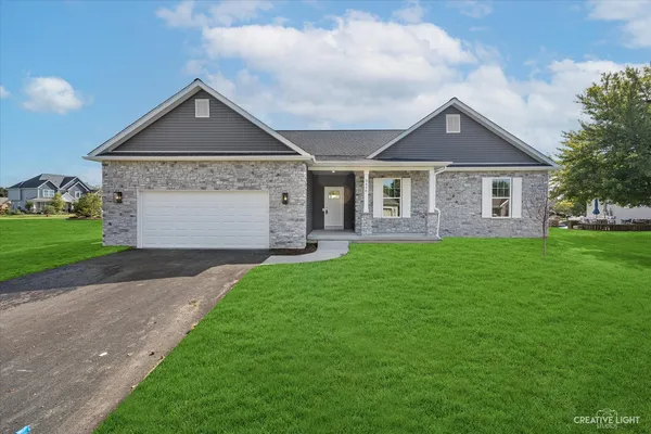 a front view of house with yard and green space