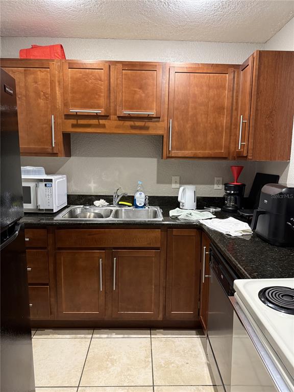 1928 South Conway Road, Unit 35 Orlando, FL 32812 - Photo 12 of 16 a kitchen with granite countertop cabinets and white appliances