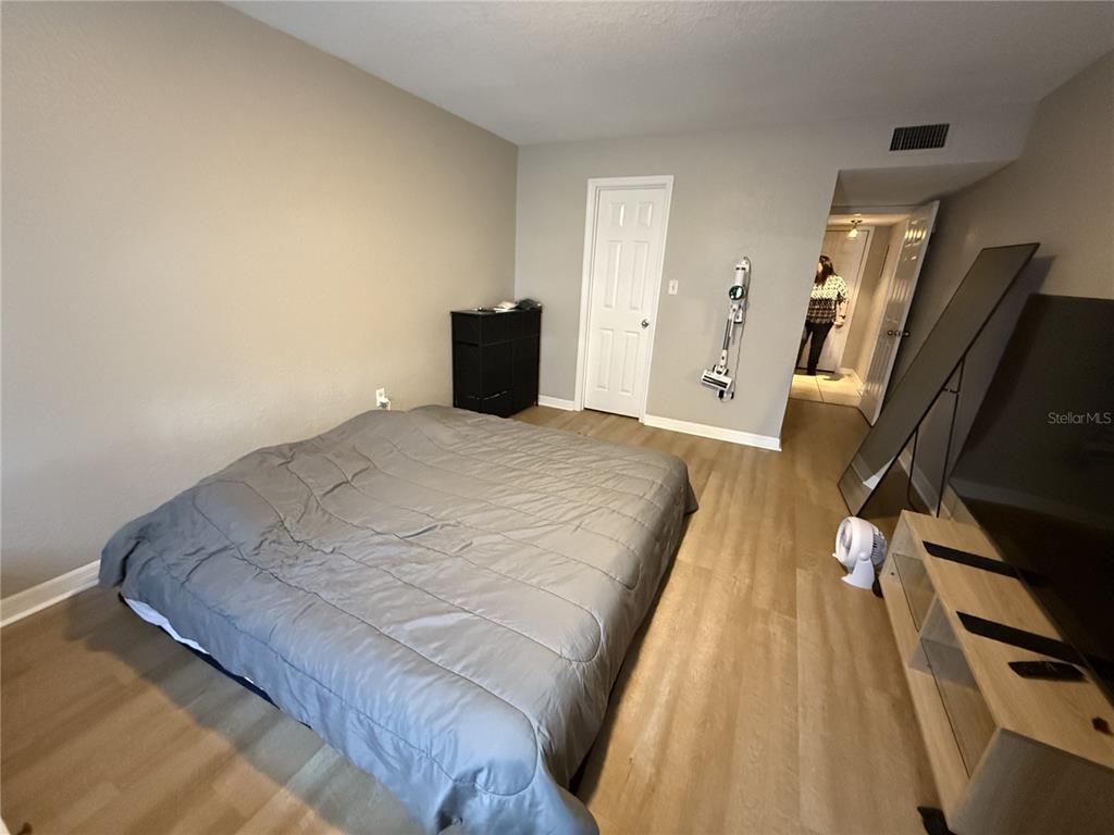 1928 South Conway Road, Unit 35 Orlando, FL 32812 - Photo 5 of 16 a bed sitting in a bedroom next to a window