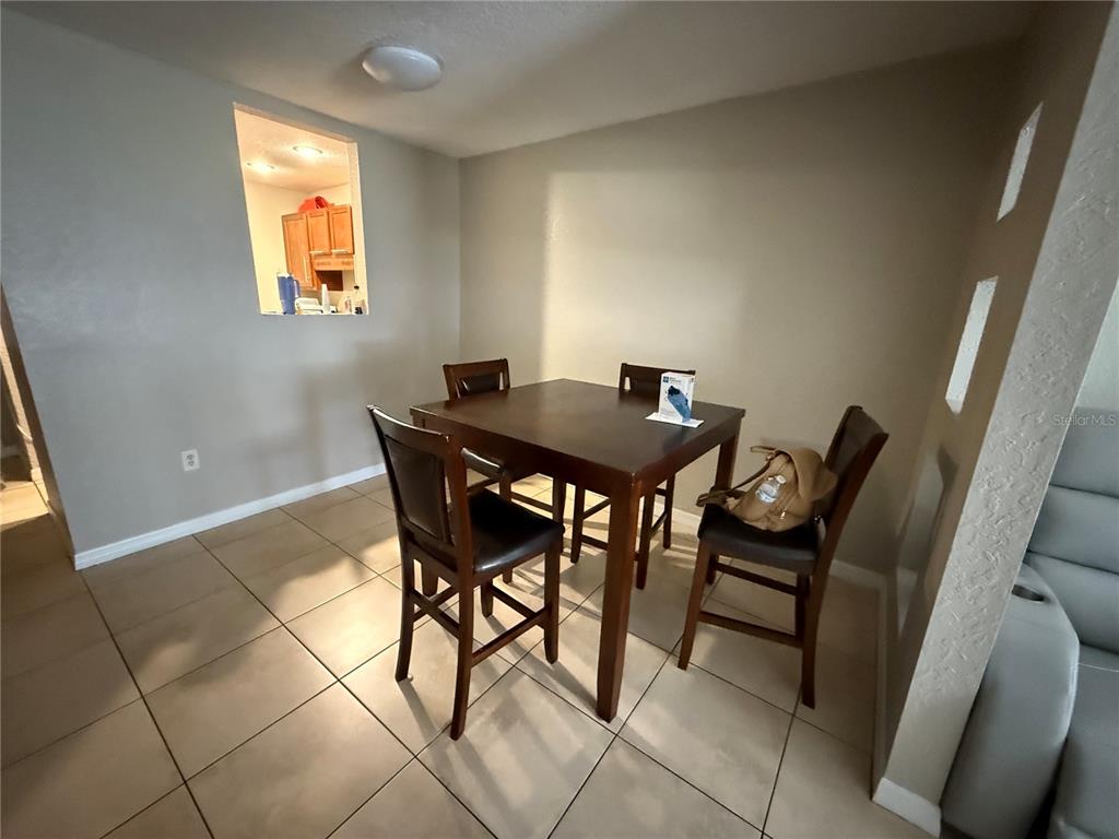 1928 South Conway Road, Unit 35 Orlando, FL 32812 - Photo 6 of 16 a view of a dining room with furniture and a window