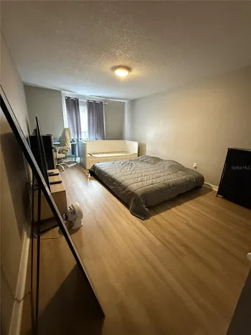 a bedroom with double bed and a window