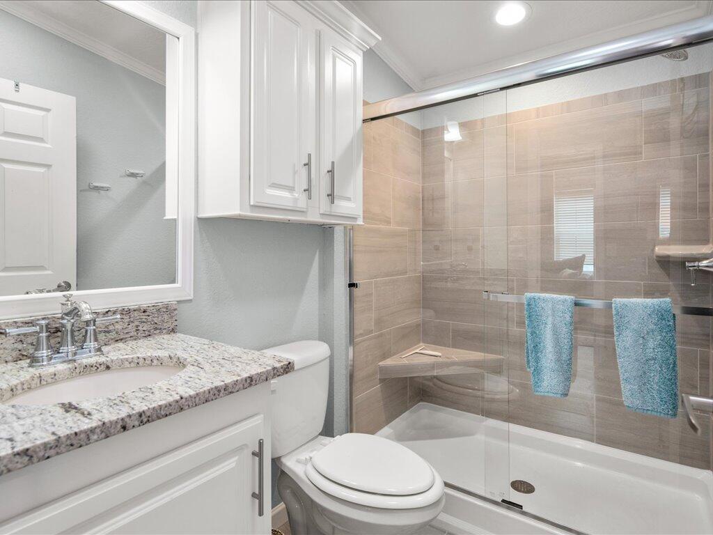 340 Pear Tree Avenue Goodland, FL 34140 - Photo 17 of 24 a bathroom with a granite countertop sink a toilet a mirror and shower