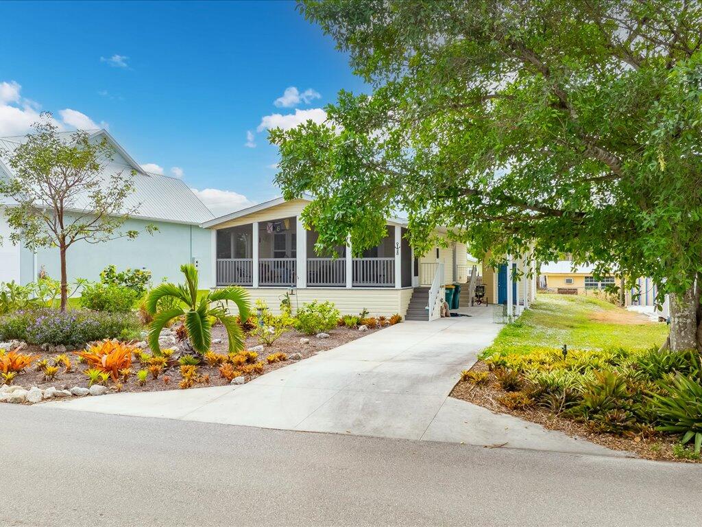 340 Pear Tree Avenue Goodland, FL 34140 - Photo 2 of 24 front view of a house with a yard and potted plants